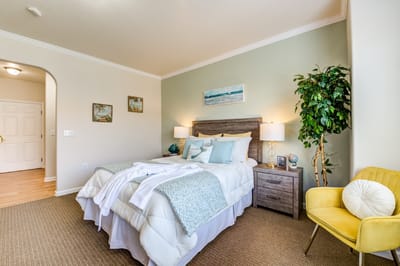 Well-decorated private room with bed and furniture