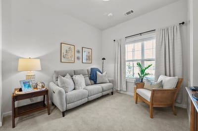Cozy living area in a resident room with natural light