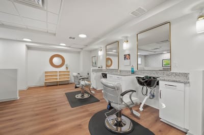Empty salon chairs in a well-lit interior space