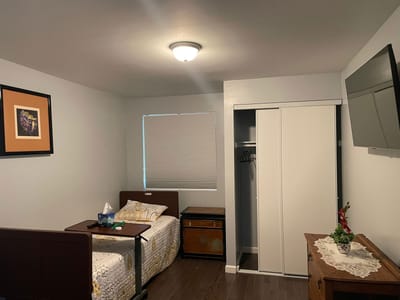 Cozy resident room with a bed and dresser