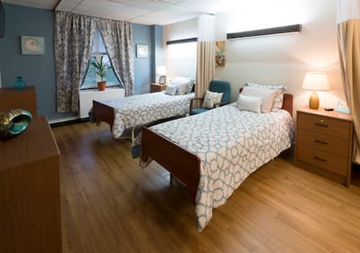 Bright, shared resident room with two beds and decor