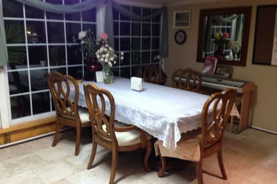 Interior dining area with a large table and flowers