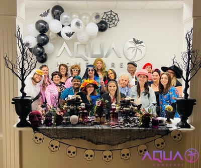 Residents and staff in colorful costumes at a Halloween celebration
