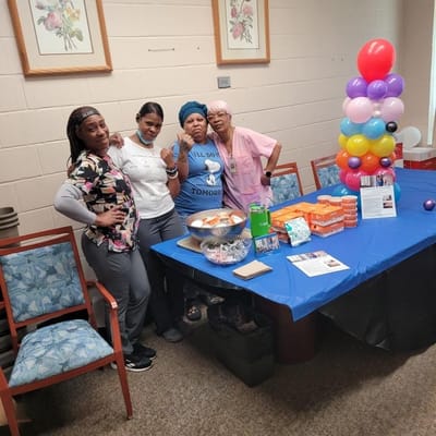 Staff members at a celebration event with food
