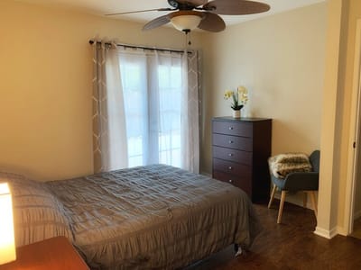 Cozy resident room with a queen bed and dresser