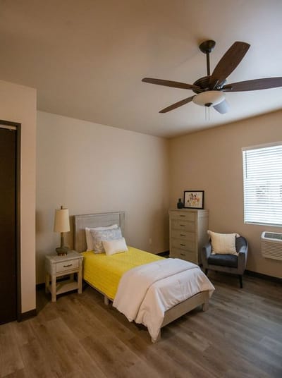 Cozy resident room with a bed and chair