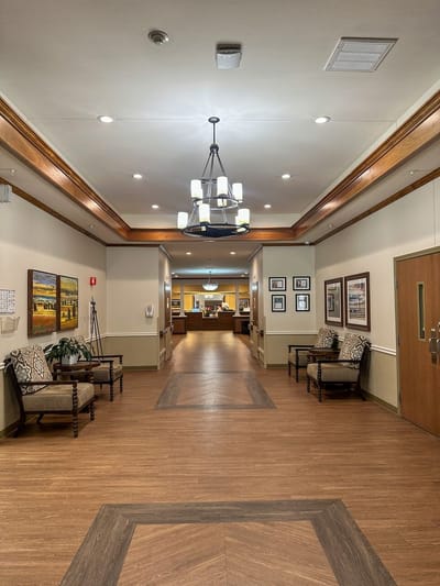 Interior corridor with wooden flooring and seating