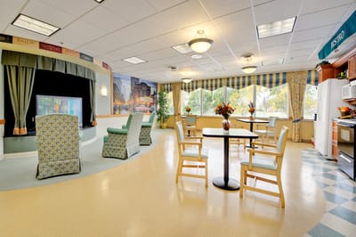 Bright interior common area with seating and kitchen