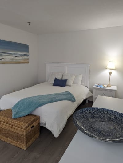 Cozy bedroom featuring a white bed and decorative elements