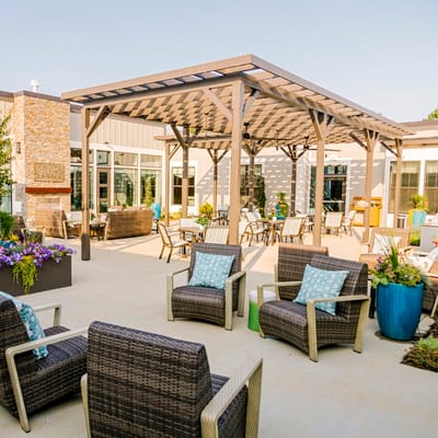 Outdoor seating area with shaded pergola and flowers