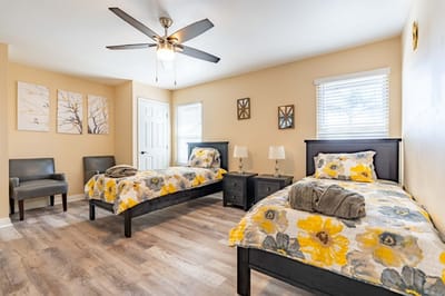Cozy shared bedroom with floral bedding and decor