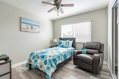 Cozy resident room with floral bedding and chair