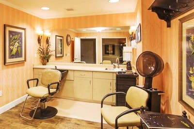Beauty salon area with styling chairs and mirrors