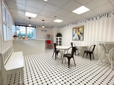 Bright common area with cafe tables and decor