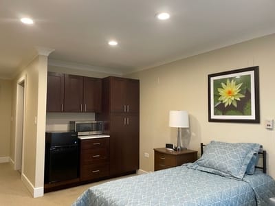 Cozy resident room with kitchenette and bed