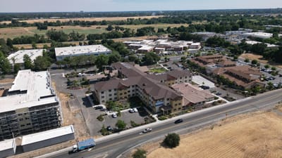 Aerial view of The Woodlake Senior Living facility and surroundings