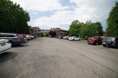 Exterior view of St. Paul Village with parked cars