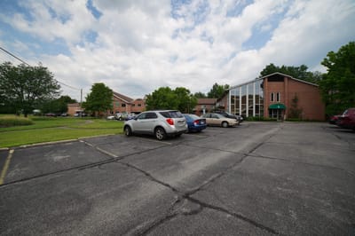 Parking lot in front of St. Paul Village with building visible