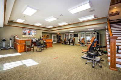 Bright activity room with exercise equipment and seating