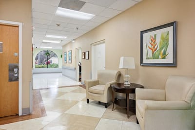 Bright interior hallway with seating area and artwork