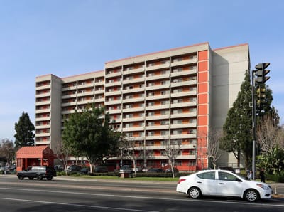 Exterior view of Flower Park Plaza building with parking area