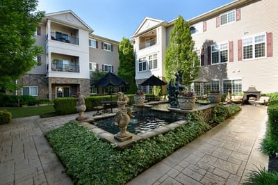 Serene outdoor courtyard with a fountain and greenery