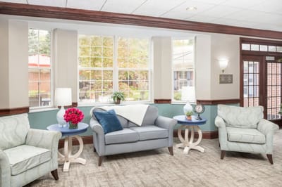 Bright common area with seating and greenery
