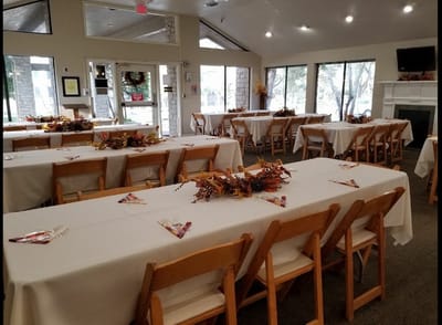 Dining area set up for an event with autumn decorations
