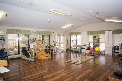 Physical therapy room with equipment and rehabilitation tools