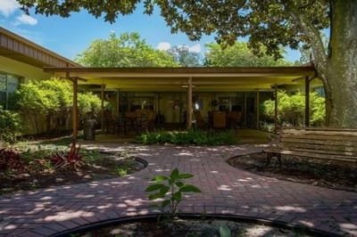 Outdoor patio area with seating and greenery
