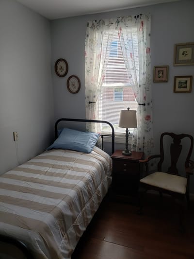 Cozy private resident room with a bed and lamp