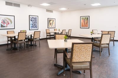Bright dining room with tables and framed art