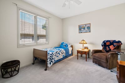 Private resident room with a bed and armchair