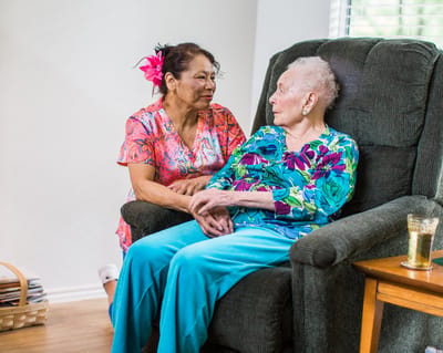 Caregiver and resident engaging in conversation