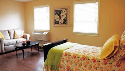 Cozy resident room with a bed and seating area