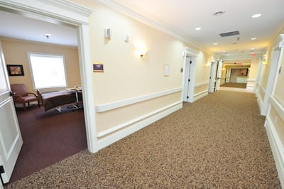 Hallway in a senior living facility with resident rooms