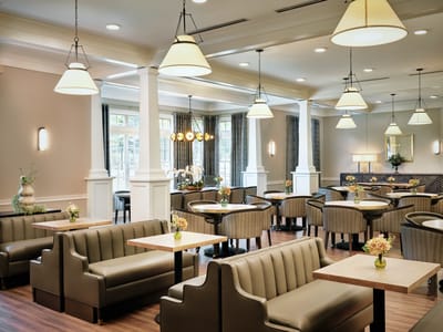Interior view of a dining area with seating and flowers