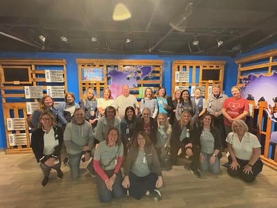 Staff members posing together in an indoor setting
