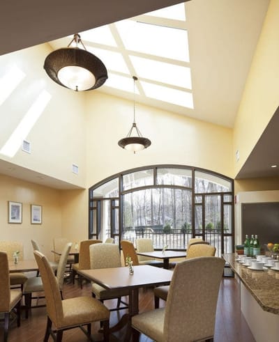 Bright dining area with large windows and tables