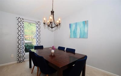 Dining area with a wooden table and blue chairs