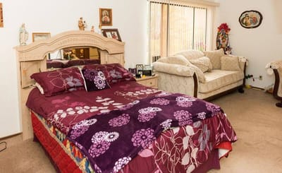 Cozy bedroom setup with a bed and sofa