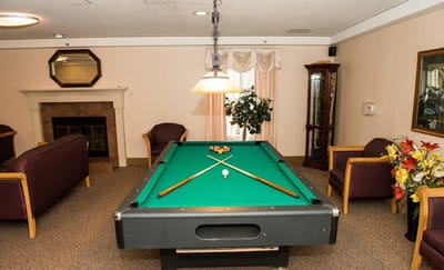 Billiard table in a common area with seating