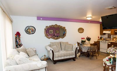 Cozy sitting area with floral decorations and kitchen