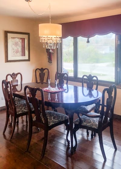 Elegant dining room with a large wooden table.