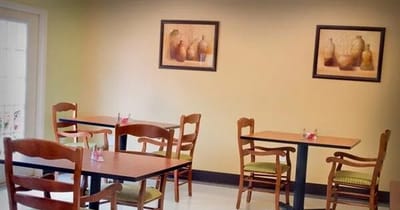 Dining area with empty tables and artwork on the walls