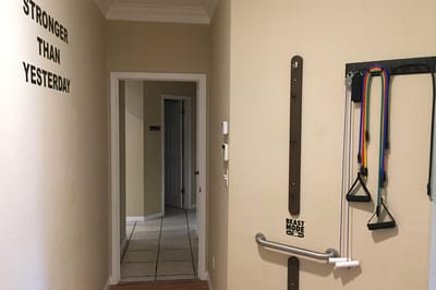 Hallway with motivational wall art and exercise equipment