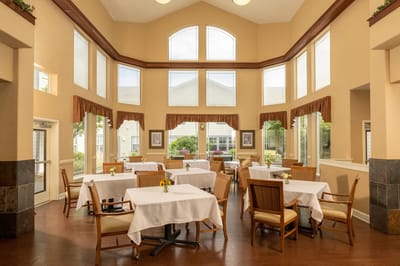 Bright and airy dining room with tables and windows