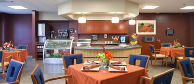 Bright dining room with tables set for meals