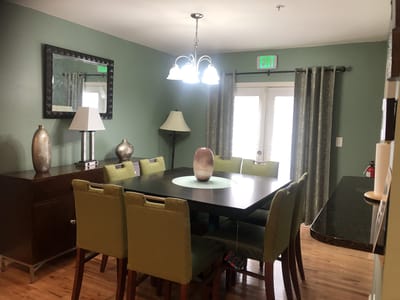 Dining area with green chairs and a large table