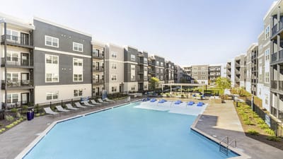 Outdoor pool area with seating and landscaping